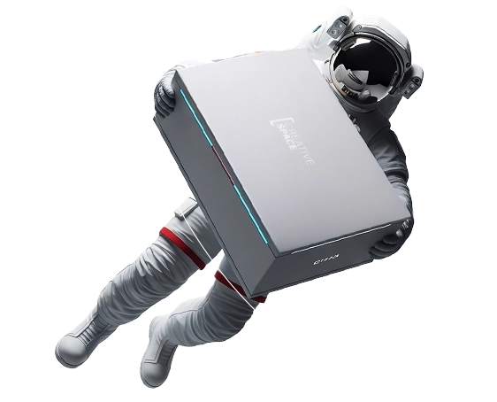 A high-resolution, 3D-rendered image of an astronaut floating diagonally in a weightless environment against a pure white background. The astronaut is wearing a detailed white extra-vehicular activity (EVA) suit featuring ribbed textures on the legs and arms, with distinct red bands around the thighs. Their helmet has a glossy, opaque black visor that reflects the studio lighting. The astronaut is holding a large, sleek, matte-grey rectangular box with both gloved hands. The box appears to be a piece of technology or product packaging. It features a thin, glowing cyan-blue light strip along the side edge. On the top face of the box, white text reads "CREATIVE SPACE" in a stylized layout. On the side of the box, a smaller logo reads "Beyond the box."